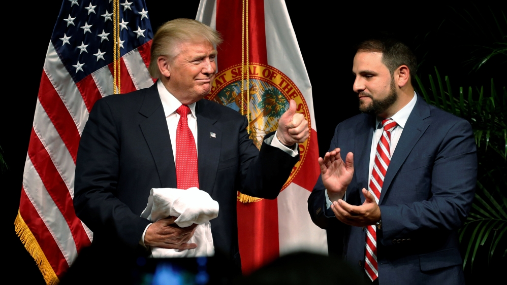 Donald Trump with Florida State Representative Carlos Trujillo at the end of a Hispanic Town Hall meeting with supporters in Miami, Florida last September [Jonathan Ernst/Reuters]