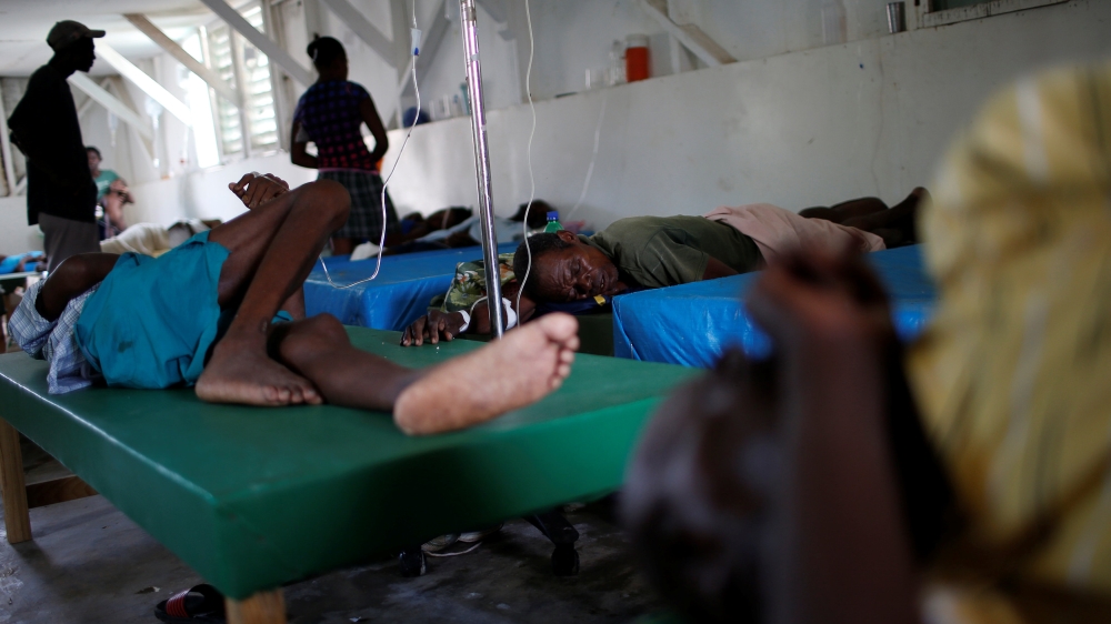 People are cared for at a cholera treatment centre in Jeremie [Carlos Garcia Rawlins/Reuters]