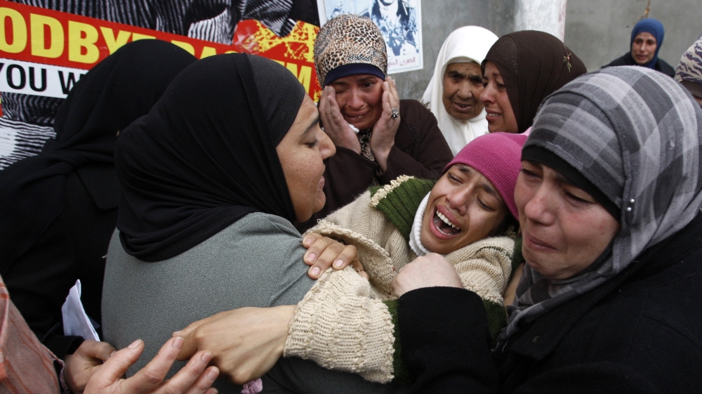 Family of Jawaher Abu Rahmah mourn her death [Mohamad Torokman/Reuters]
