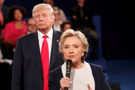 Republican U.S. presidential nominee Trump listens as Democratic nominee Clinton answers a question from the audience during their presidential town hall debate in St. Louis