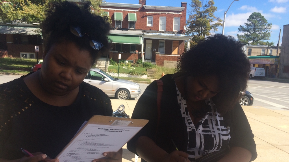 Tabitha Williams and Nicole Garnett registered to vote as they came to the Matthew Henson school for work [Cajsa Wikstrom/Al Jazeera]