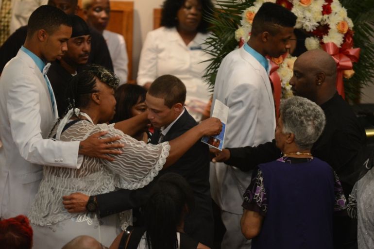 Gwen Carr hugs Ramsey Ortiz during the funeral service of Eric Garner at Bethel Baptist Church in Brooklyn New York