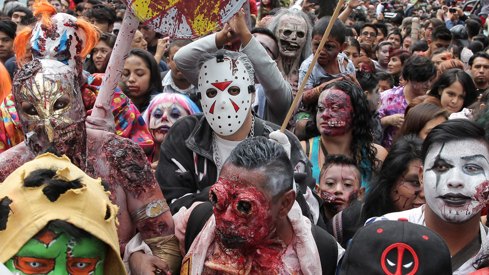 Hundreds of people dressed as Zombies participate in the ninth edition of the Zombie Parade through the main avenues of Mexico City [Alex Cruz/EPA]
