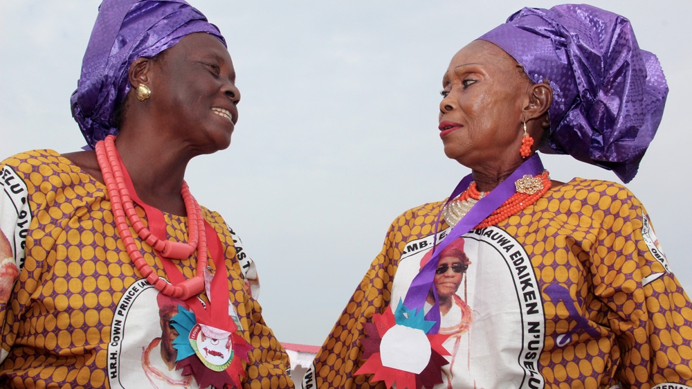 Bini women were dresses made of fabric featuring portraits of the new Oba [Femke van Zeijil/Al Jazeera] 
