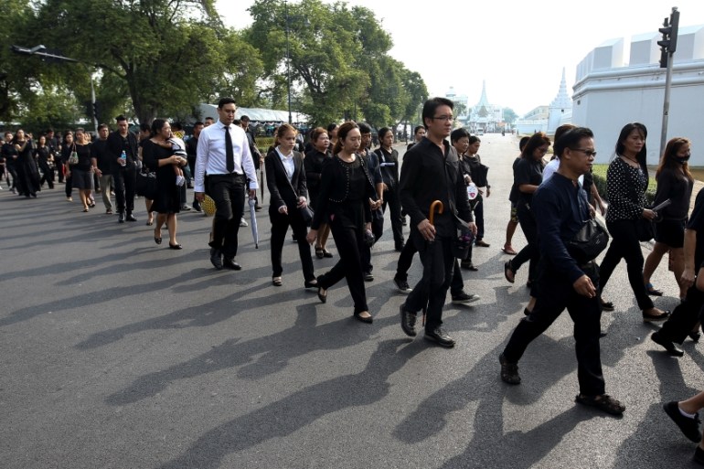 Mourners walk in line to offer condolences to Thailand''s late King Bhumibol at the Grand Palace in Bangkok