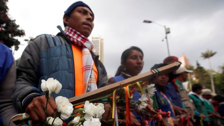 Indigenous Colombians rally for an imminent resolution to the nation’s peace agreement during a march with white flowers in Bogota, Colombia