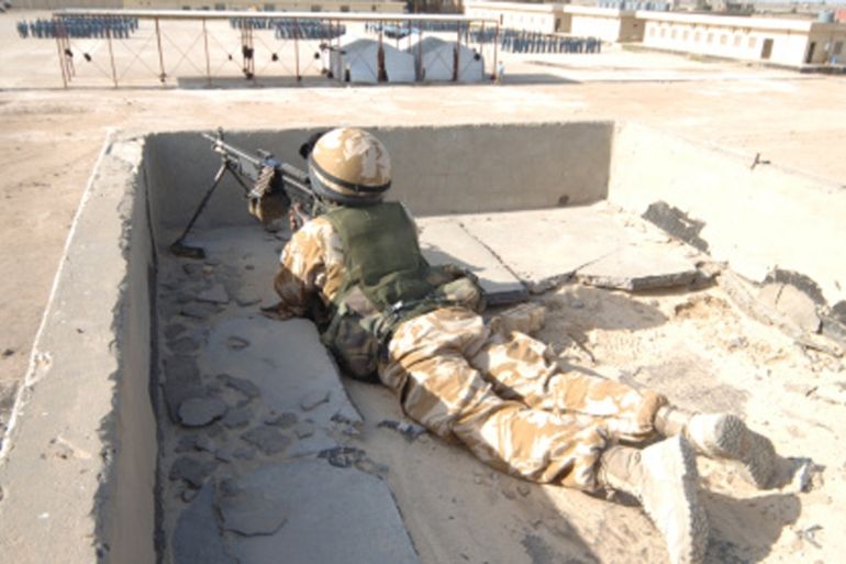 A British soldier provides security from a rooftop in Basra, Iraq [Getty]