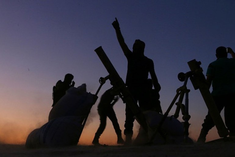 FSA fighters cheer and react as they fight against ISIL on the outskirts of the northern Syrian town of Dabiq [Getty]