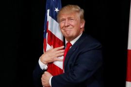 Trump hugs a U.S. flag