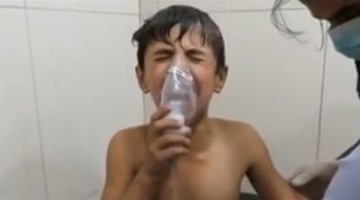 A Syrian boy breathing with an oxygen mask inside a hospital, after a suspected chlorine gas attack in Syria [Reuters]