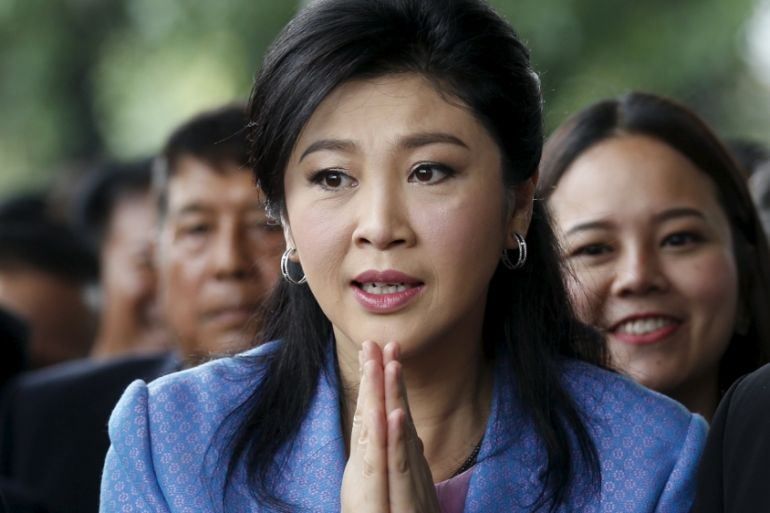 Ousted former Thai Prime Minister Yingluck Shinawatra gestures as she arrives at the Supreme Court in Bangkok