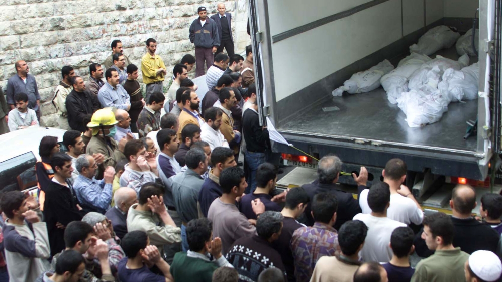 Palestinians pray near a truck containing the bodies of Mahmoud's eight family members [Abed Omar/Reuters]