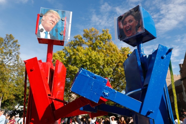 Robots with portraits of Trump and Clinton before the presidential debate in St. Louis, Missouri, US [REUTERS]
