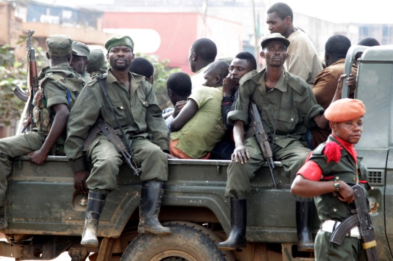 Congolese soldiers ride on their pick-up truck after dispersing civilians protesting against the government''s failure to stop the killings and inter-ethnic tensions in the town of Butembo