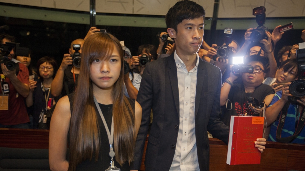 Yau Wai-ching (left) and Sixtus Leung modified their oaths in an act of defiance by using a derogatory word for China [EPA]