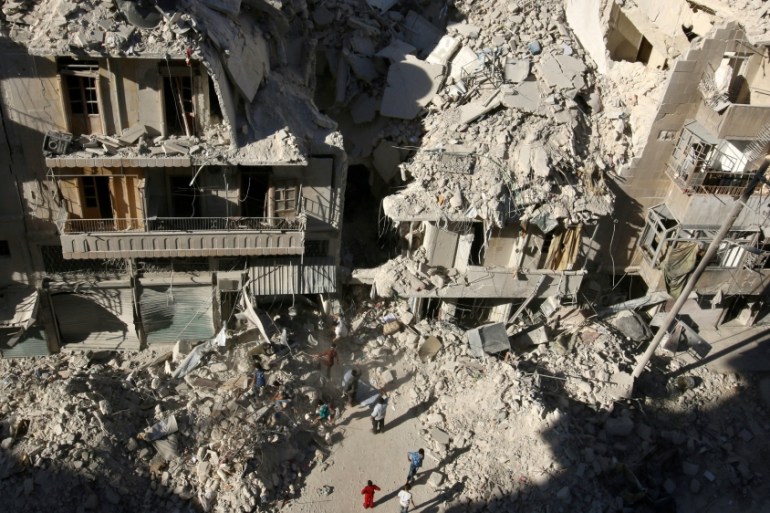 FILE PHOTO: People dig in the rubble in an ongoing search for survivors at a site hit previously by an airstrike in the rebel-held Tariq al-Bab neighborhood of Aleppo