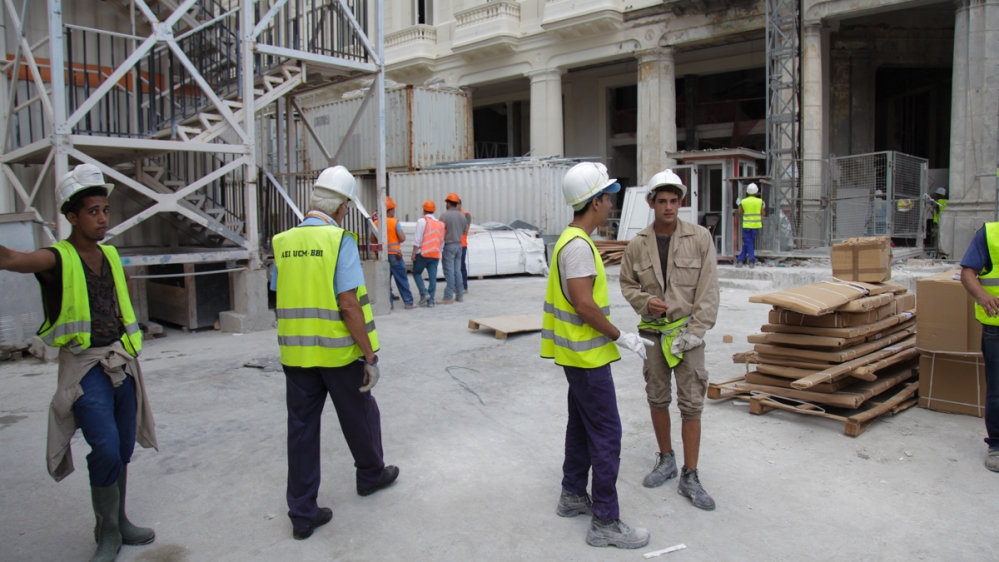 Cuban labourers working on the restoration of the Manzana de Gomez earn far less than their Indian counterparts [Ed Augustin/Al Jazeera]
