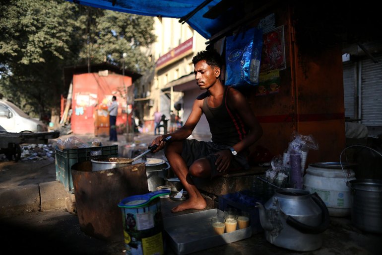 Indian Chai wala makes tea by the side of a road