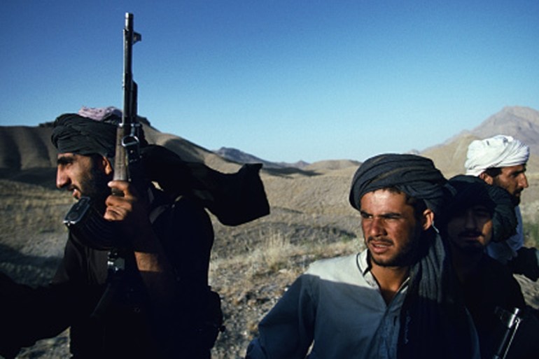 Unidentified armed Taliban soldiers ride on a pick-up truck outside Kabul, Afghanistan [Getty]