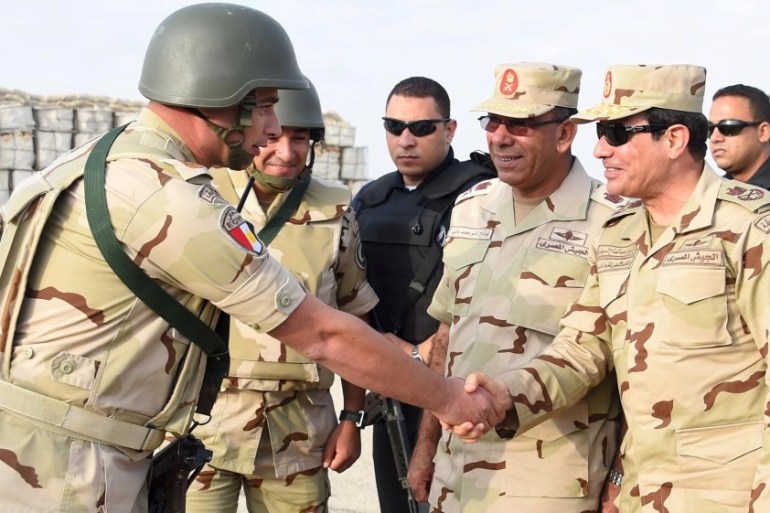 Egyptian President Sisi greets members of the Egyptian armed forces, after travelling to the troubled northern part of the Sinai peninsula to inspect troops