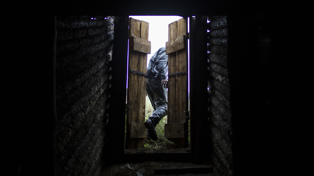 A herder leaves an underground potato cellar in Ikh Tamir [Taylor Weidman/Al Jazeera]