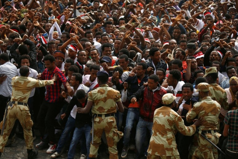 File photo of demonstrators chanting slogans while flashing the Oromo protest gesture during Irreecha, the thanksgiving festival of the Oromo people, in Bishoftu town, Oromiya region, Ethiopia