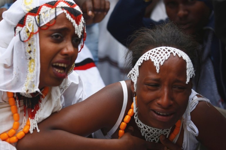 Women react at a protest during Irreecha, the thanksgiving festival of the Oromo people, in Bishoftu town, Oromia region, Ethiopia
