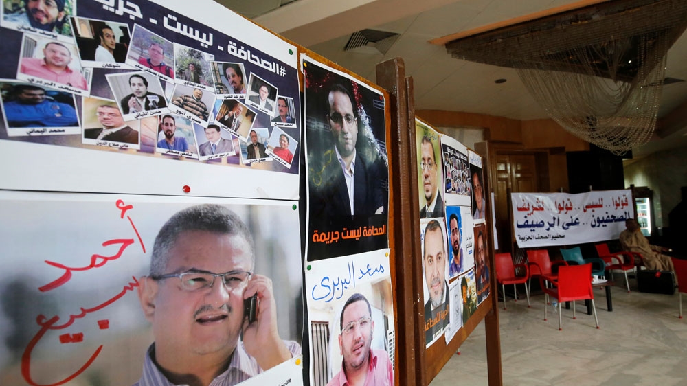 Pictures of arrested journalists are seen on World Press Freedom Day in May in Cairo [Reuters]