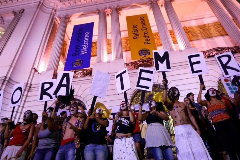People holding placards against Brazil''s President Michel Temer,