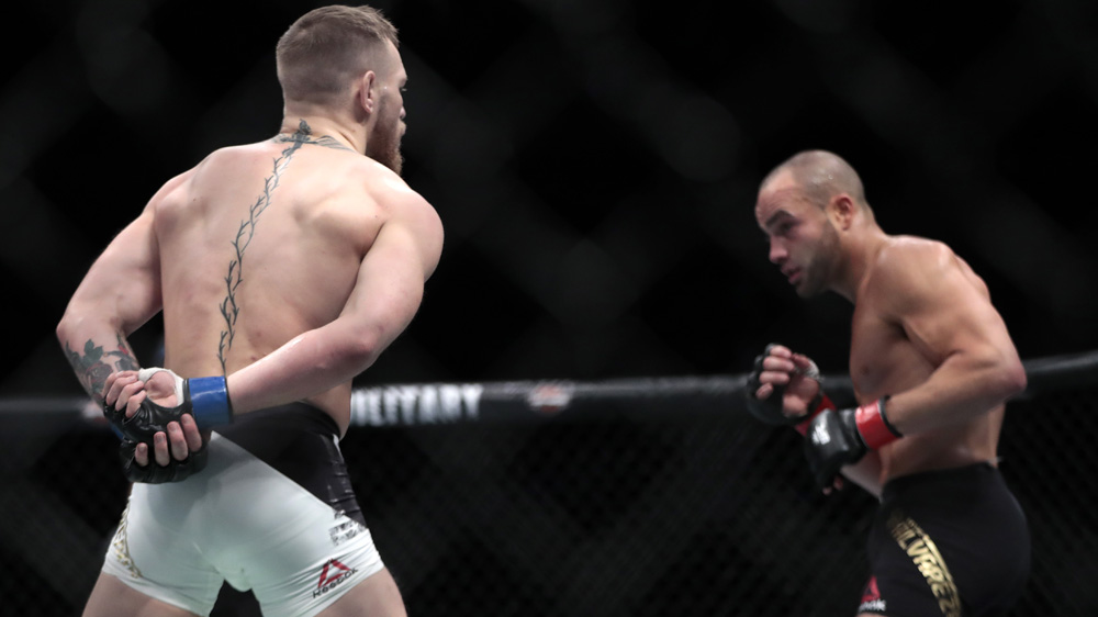Conor McGregor, left, fights Eddie Alvarez during a lightweight title mixed martial arts bout at UFC 205 at Madison Square Garden in New York [Julio Cortez/AP]