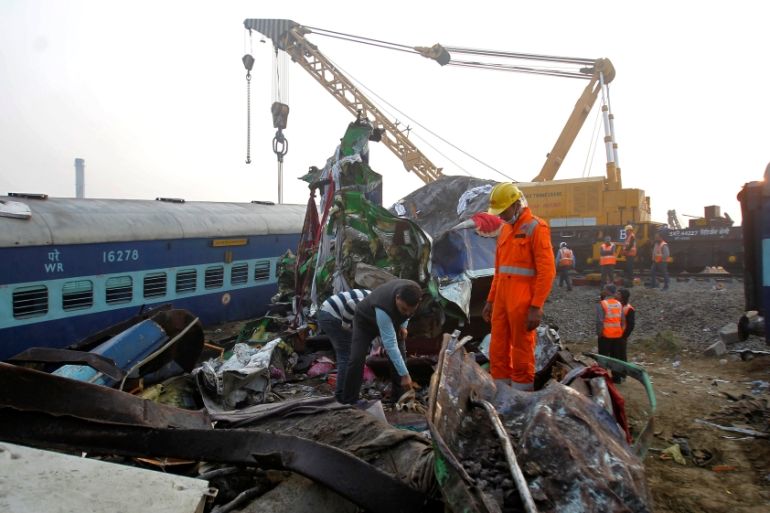 Rescue workers search for survivors at the site of Sunday''s train derailment in Pukhrayan, south of Kanpur city