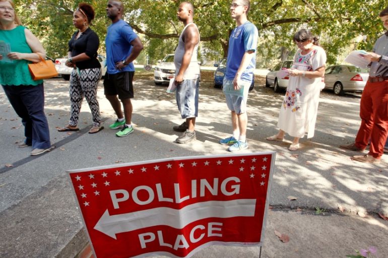 People arrive to cast their ballot for 2016 elections at a polling station as early voting begins in North Carolina, in Carrboro, North Carolina