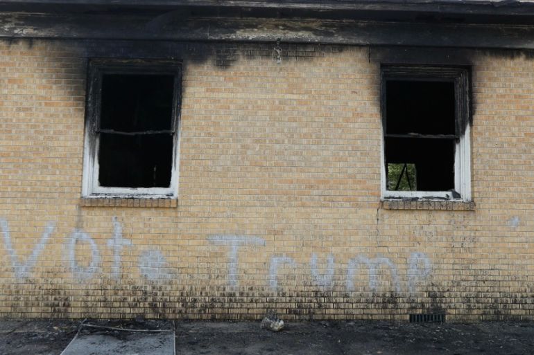 "Vote Trump" is spray painted on the side of the fire damaged Hopewell M.B. Baptist Church in Greenville