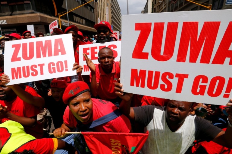 Protestors call for the removal of President Jacob Zuma outside court in Pretoria, South Africa