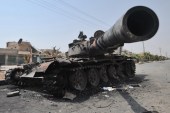 A destroyed Syrian government tank on a street near Aleppo, Syria, in July 2012 [EPA]