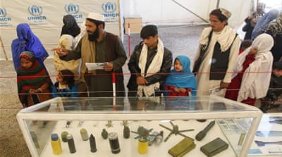 Returnees at the UNHCR processing centre get a quick lesson in defusing explosive devices [Al Jazeera]