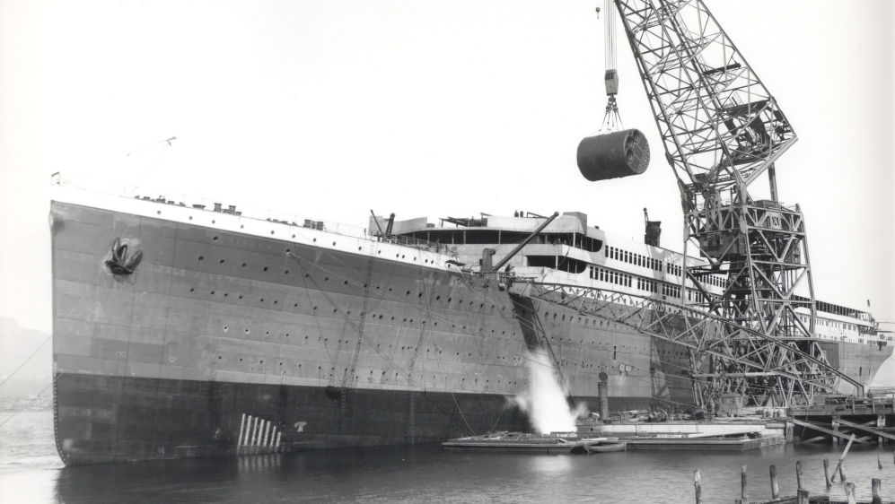 A giant crane lowers a 490-tonne boiler into Britannic’s hull [Courtesy Simon Mills]