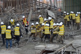Rescue workers search at the site where a power plant''s cooling tower under construction collapsed in Fengcheng