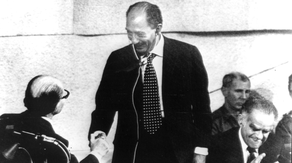 
 Egyptian President Anwar al-Sadat shakes hands with former Israeli PM Menachem Begin after addressing the Israeli government on November 20, 1977  [The Associated Press]
