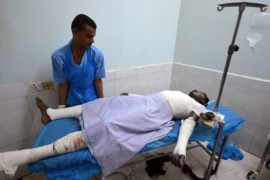 Medic helps a man injured by Saudi-led air strikes on a prison near the Red Sea port city of Houdieda, Yemen