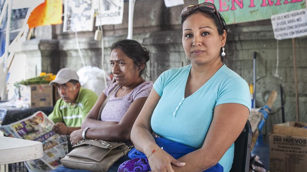 Eva, right, is a union teacher from Tuxtepec who is protesting against the economic disparities of thousands in Oaxaca [Gabriela Campos/Al Jazeera]
