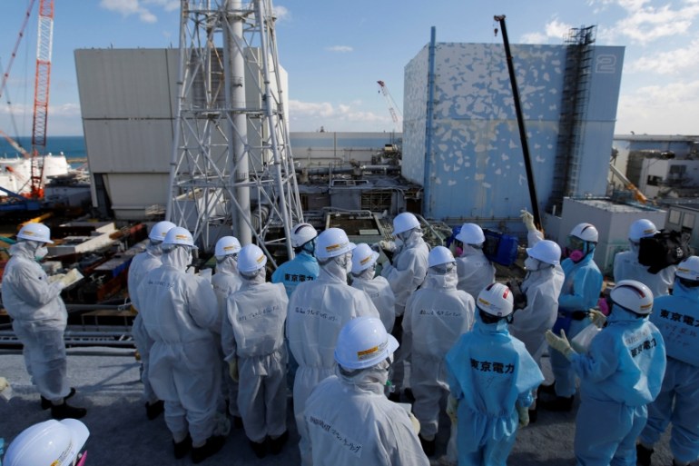 Members of the media receive briefing from Tokyo Electric Power Co. employees at tsunami-crippled Fukushima Daiichi nuclear power plant in Okuma town, Fukushima prefecture