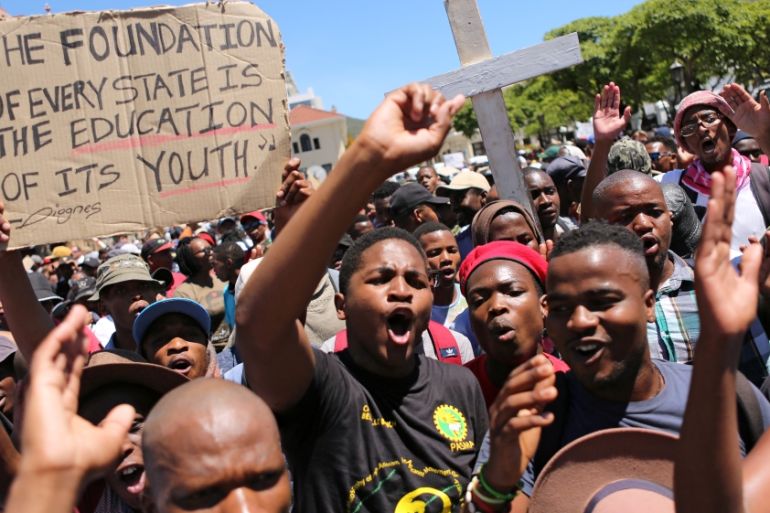 Students protest outside the parliament ahead of South African Finance Minister Pravin Gordhan''s medium term budget speech in Cape Town