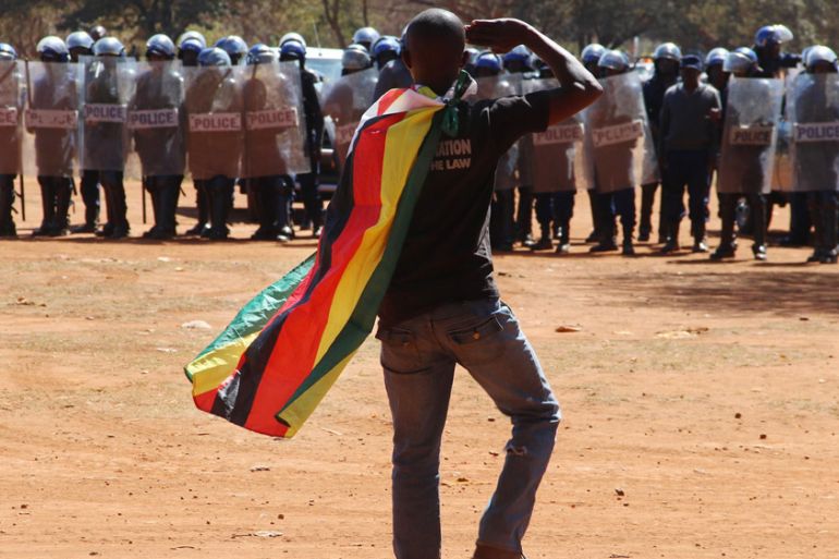 A man wearing a Zimbabwean flag