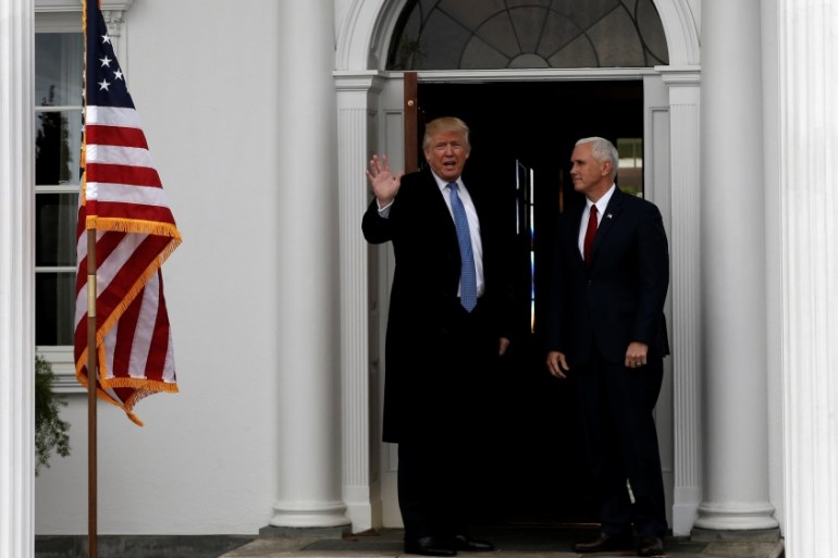 U.S. President-elect Donald Trump and Vice President-elect Mike Pence stand at the entrance to the main clubhouse at Trump National Golf Club in Bedminster