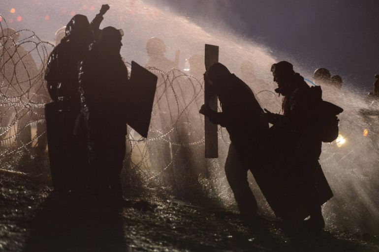 Police use a water cannon on protesters during a protest against plans to pass the Dakota Access pipeline near the Standing Rock Indian Reservation, near Cannon Ball, North Dakota, U.S.