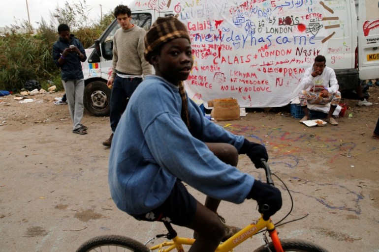 A young boy, one of some 1,500 migrant minors housed temporarily in converted shipping containers since the evacuation last week of the Jungle camp, rides a bicycle in Calais