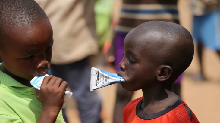 Boys drink packs of evaporated milk at the camp for internally displaced people in Abuja