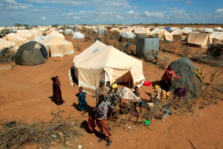 Refugees stand outside their tent at the Ifo Extension refugee camp in Dadaab, near the Kenya-Somalia border in Garissa County, Kenya