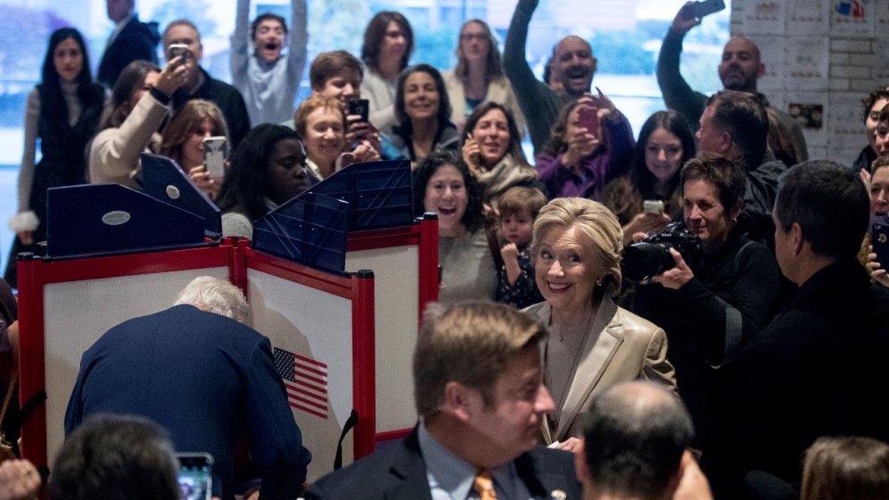 Hillary Clinton was accompanied by her husband, Bill, and senior aide Huma Abedin, far left [Andrew Harnik/AP]